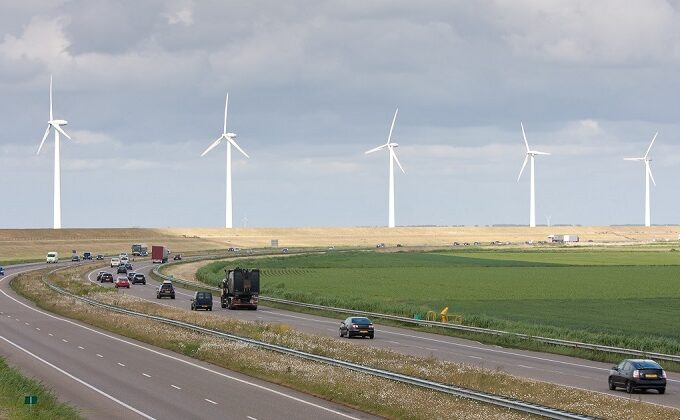 highway traffic in front of wind turbines||||highway traffic in front of wind turbines|highway traffic in front of wind turbines