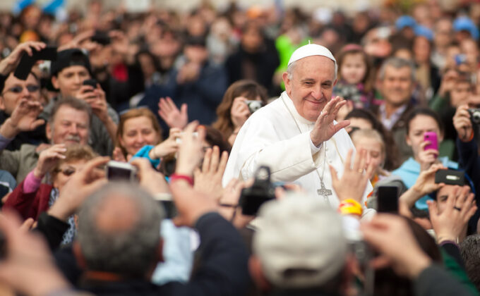 Pope Francis waves toward crowd|Pope Francis waving toward crowd|Pope Francis waves toward crowd.