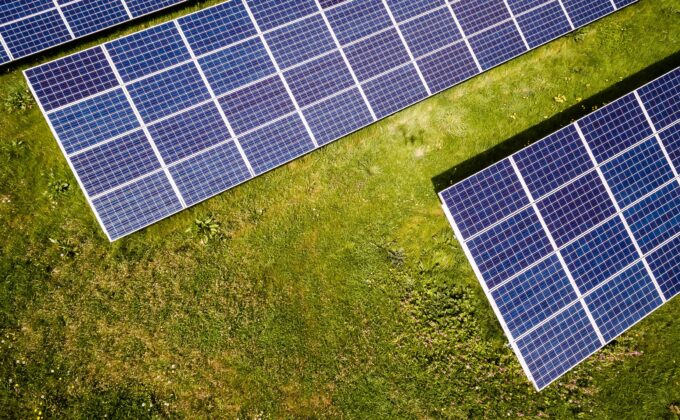 solar panels from above|man working on solar panel||farm field with mountains