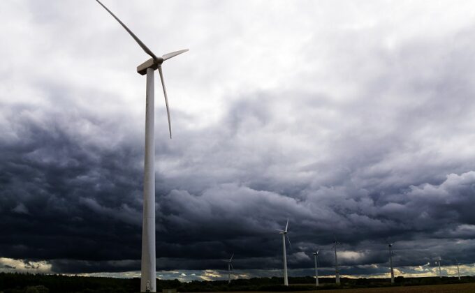 wind turbines in field under storm clouds|wind turbines in field under storm clouds|wind turbines in field under storm clouds|wind turbines in field under storm clouds