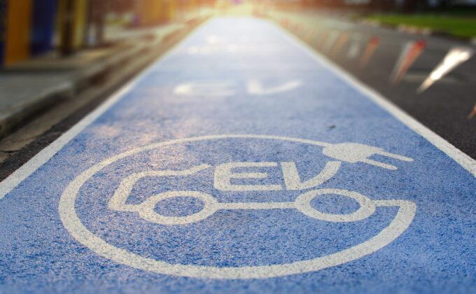 A road lane paved with an electric-vehicle symbol