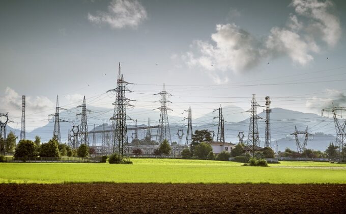 transmission towers in front of mountains