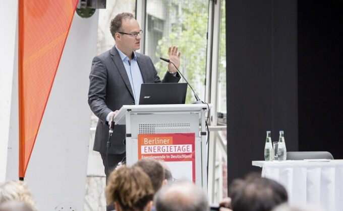 Dr. Jan Rosenow speaking at a podium at Berlin Energy Days conference|Dr. Jan Rosenow speaking at a podium at Berlin Energy Days conference