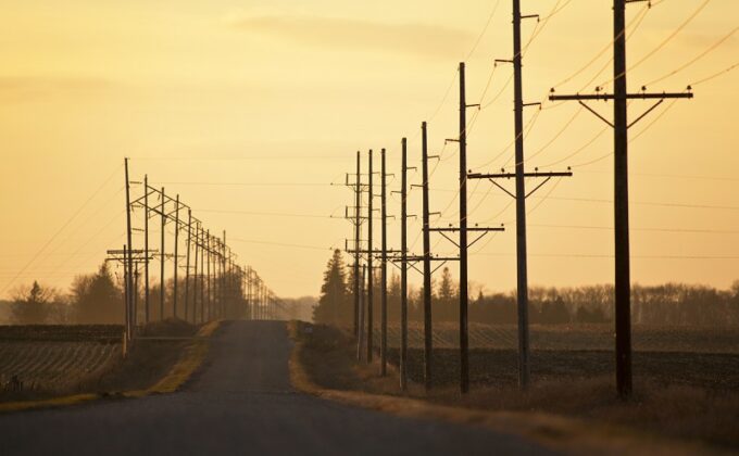 power lines along country road against yellow sky|power lines along country road against yellow sky|power lines along country road against yellow sky|power lines along country road against yellow sky