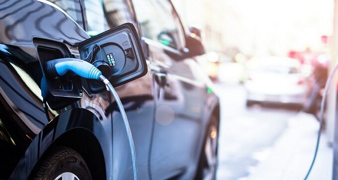 black electric car attached to a charging station|black electric car attached to a charging station|black electric car attached to a charging station