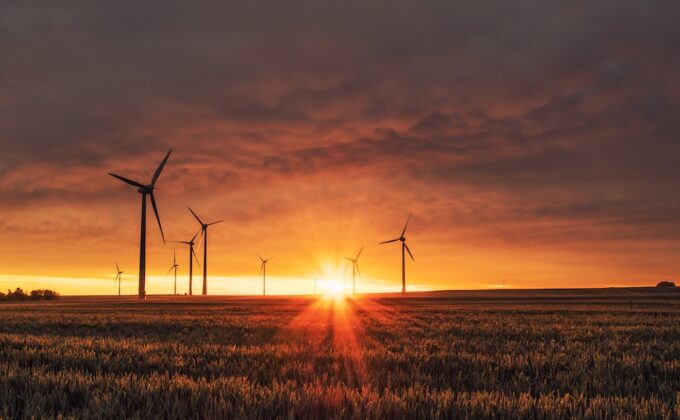 Wind Turbines in farm field at sunset