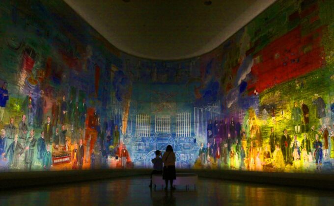 image of an adult and a child sitting in front of Raoul Dufy's fresco la fee electricite