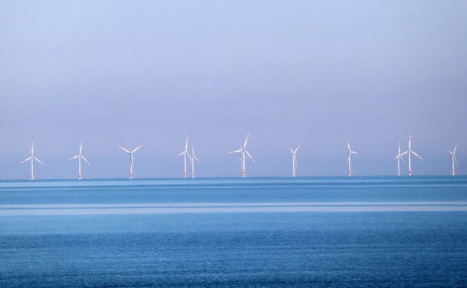 Wind turbines in the water off the coast of a European country|Wind turbines in the water off the coast of a European country