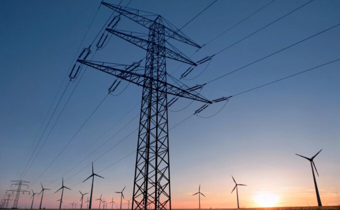 overhead power line in front of wind turbines