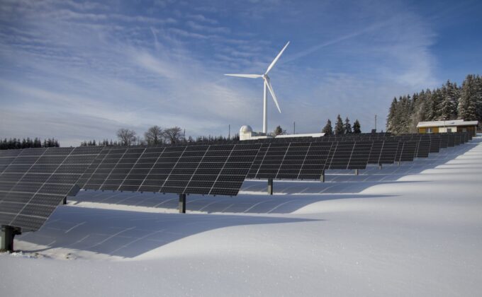 wind turbine and solar panels in snow