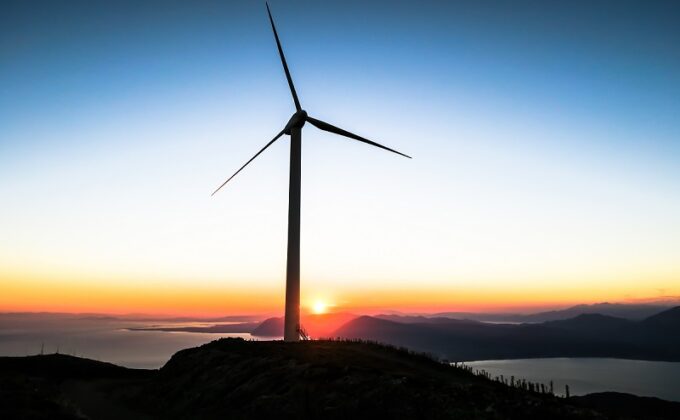 wind turbine lake and sun on horizon|wind turbine lake and sun on horizon|wind turbine lake and sun on horizon