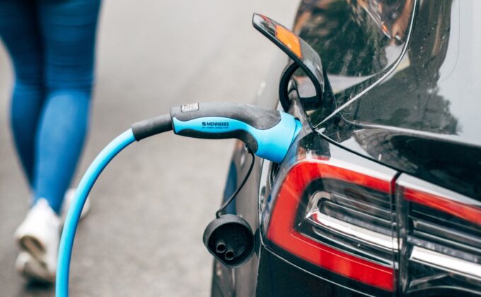 charging cable plugged into black electric vehicle