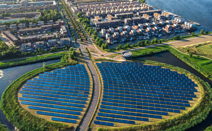 aerial view of round solar farm and semi-urban neighborhood