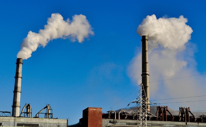 Steam rises out of towers at a coal power plant.