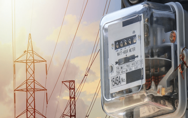 Utility meter with transmission lines in background