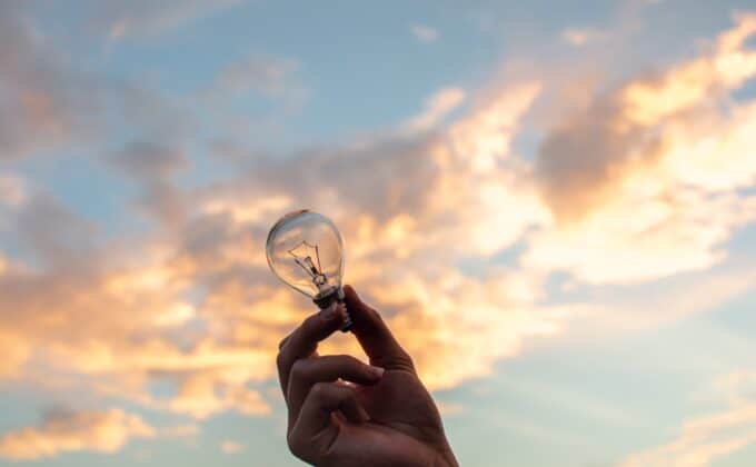 hand holding light bulb