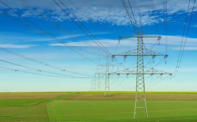 Transmission towers and lines in green field Verteilungsnetz Infrastruktur im grünen Feld